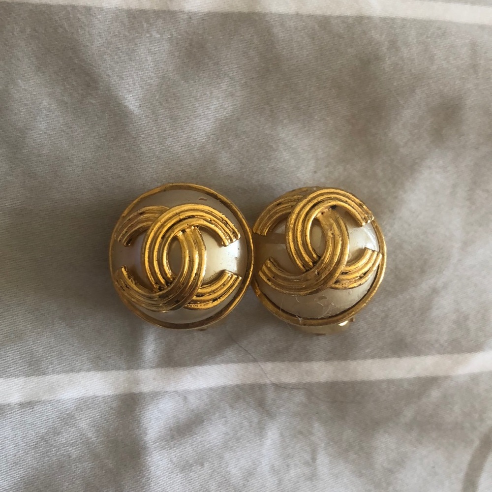 Chanel gold and pearl logo clip on earrings.